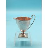 A George III silver milk jug, helmet-shape on square pedestal base, Henry Chawner, London 1791,