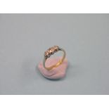 An 18ct. gold diamond half-hoop ring, three small diamonds in platinum claw settings, size L