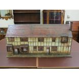 A terraced cottage model, timber-framed with pitched, tiled roof, 32in. wide