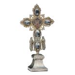 A cross in in molten, embossed and chiselled silver and engraved and faceted rock [...]