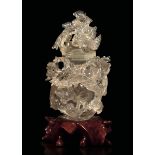 A rock crystal vase, China, early 1900s - Carved with a perforated decor depicting a [...]