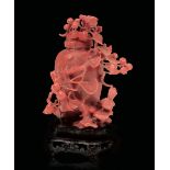 A small coral sculpture, China, early 1900s - A coral vase with a bird among [...]