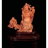 A coral figure, China, early 1900s - A Budai with a peach tree branch. H 11cm, 390gr [...]