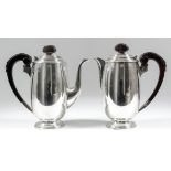 A George VI silver coffee pot and matching hot water jug of "Art Deco" design, with reeded mounts to