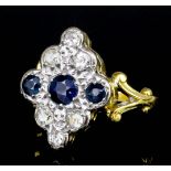 A modern 18ct gold sapphire and diamond ring, the face set with circular cut sapphire of