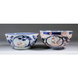A Chinese Famille Rose porcelain bowl painted with figures in landscapes within shaped reserves,