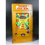 A 1950s oak cased "Penny-in-the Slot" "Double Your Win" Alwin flicker machine with "2-4-6" pay-