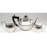 A harlequin Victorian/Edwardian bachelors silver three piece oval tea service with part reeded