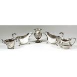 Two Elizabeth II silver sauce boats with gadroon mounts, leaf capped double C-scroll handles and