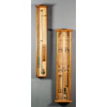 Two late Victorian oak cased "Admiral Fitzroy's" barometers with paper scales and in plain