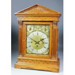 A late Victorian oak cased mantel clock, the 9ins brass dial with silvered chapter ring with Roman