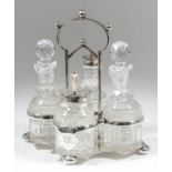 An Edward VII silver four division cruet stand of shaped outline, the central loop handle with