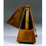 A late 19th Century English walnut cased metronome, the cast gilt plaque of the front worded - "Best