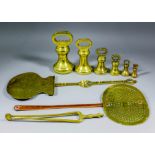 A collection of Victorian and George V brass bell-shaped weights from .25oz to 7lbs, .75ins to
