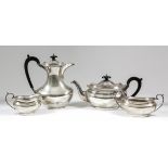 A George V silver four piece tea service, the plain oval squat bodies with gadroon mounts to rim,