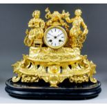 A late 19th Century French gilt metal cased mantel clock, the 3ins diameter white enamel dial with