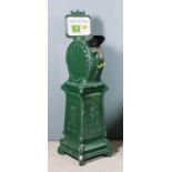A good late 19th Century/early 20th Century American green painted cast iron "Penny-in-the-Slot" "