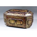 A Chinese black lacquer octagonal tea caddy decorated in gilt and red with scenes of figures in