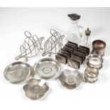 Two Victorian and Edwardian silver four division toast racks of oval form, with loop handles and