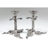 A pair of Italian silver pillar candlesticks, the sconces with bead and leaf pattern mounts, on