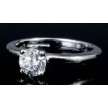 A modern platinum mounted diamond solitaire ring, the brilliant cut stone of approximately .65ct (