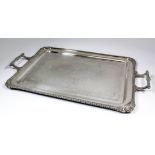 A plated rectangular two-handled tray with gadroon shell and scroll mounts, the centre engraved with