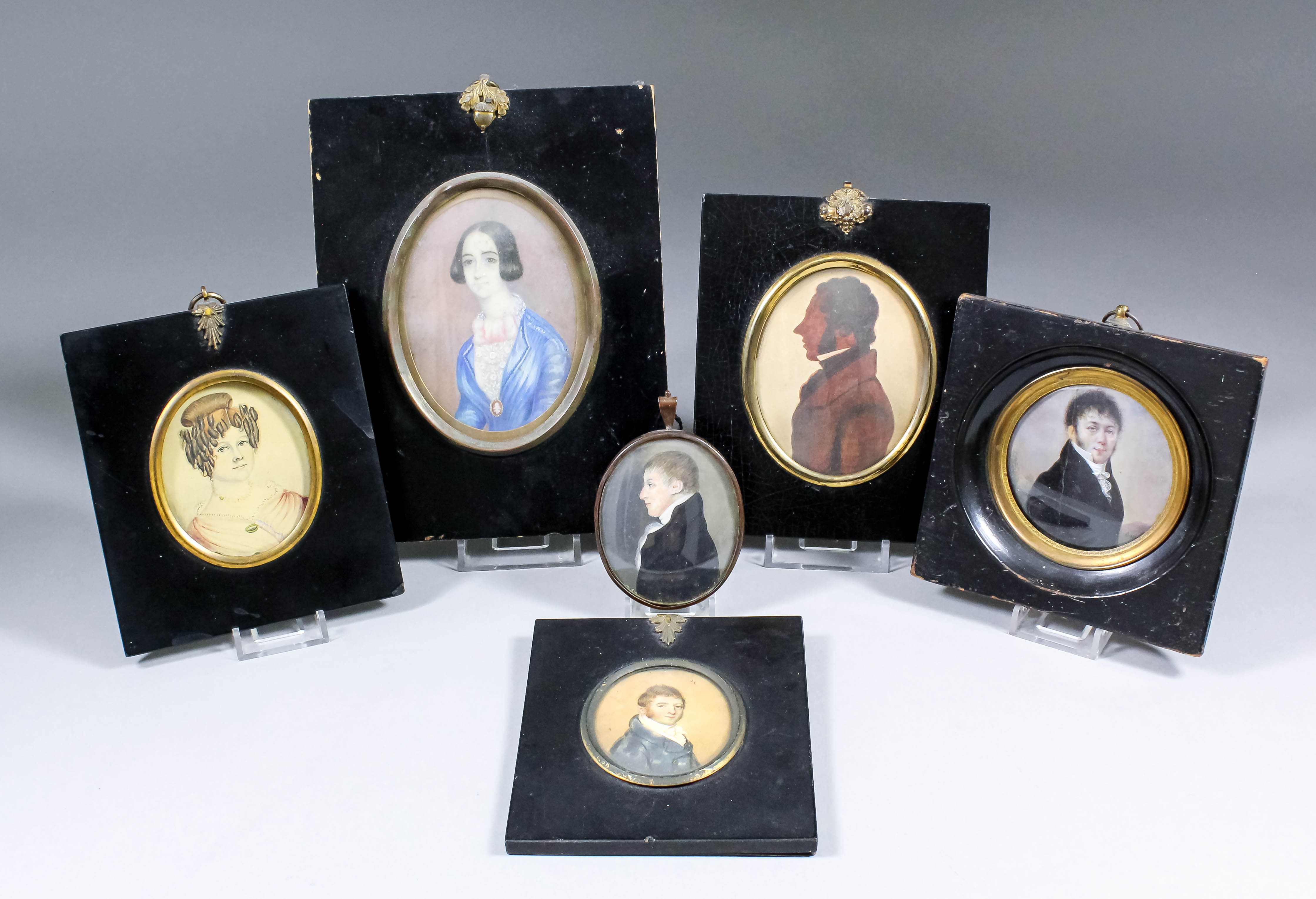 A late 18th/early 19th Century miniature shoulder-length portrait of a young man with blue frock