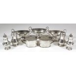 Three Edward VII silver oval two-handled salts with reeded mounts, high scroll handles and footrims,