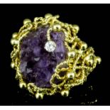 A modern 18ct gold mounted, Deacon and Francis amethyst and diamond set ring, the natural amethyst