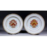 A pair of Chinese export Armorial porcelain plates, the centres painted and decorated in gilt with a