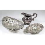 A late Victorian silver oval basket with scroll cast rim and pierced sides, 12ins x 7ins, by