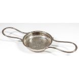 A George III silver circular two-handled lemon strainer with reeded loop handles, the circular