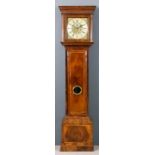 An 18th Century walnut longcase clock with later movement, the 12ins square brass dial with wide