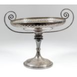 @A George V silver circular two-handled tazza with pierced rim, scroll handles, knopped stem and