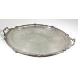 An Edward VII silver oval two-handled tray, the fluted rim with shell and leaf capped mounts, reeded