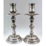 A pair of Portuguese silver pillar candlesticks of "17th Century" design, with hammered finish, deep