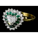 A modern 18ct white and yellow gold mounted emerald and diamond set ring, the heart cut diamond of