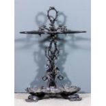 A Victorian black painted cast iron umbrella stand in the "Colebrookdale" manner, the shaped
