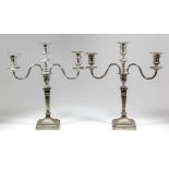 A pair of Edward VII silver pillar candlesticks of "Neo Classical" design, the urn pattern
