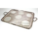 A plated rectangular two-handled tray with reeded and ribbon pattern mounts to edge and leaf