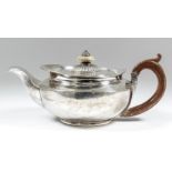 A George III silver circular teapot of squat form, the part reeded cover with turned finial, plain