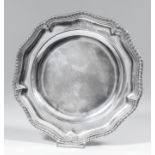 A mid-18th Century silver plate of shaped outline, with gadroon mounts to rim, 9.5ins diameter, by