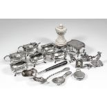 A George V silver rectangular six piece condiment set with gadroon and scroll cast mounts,