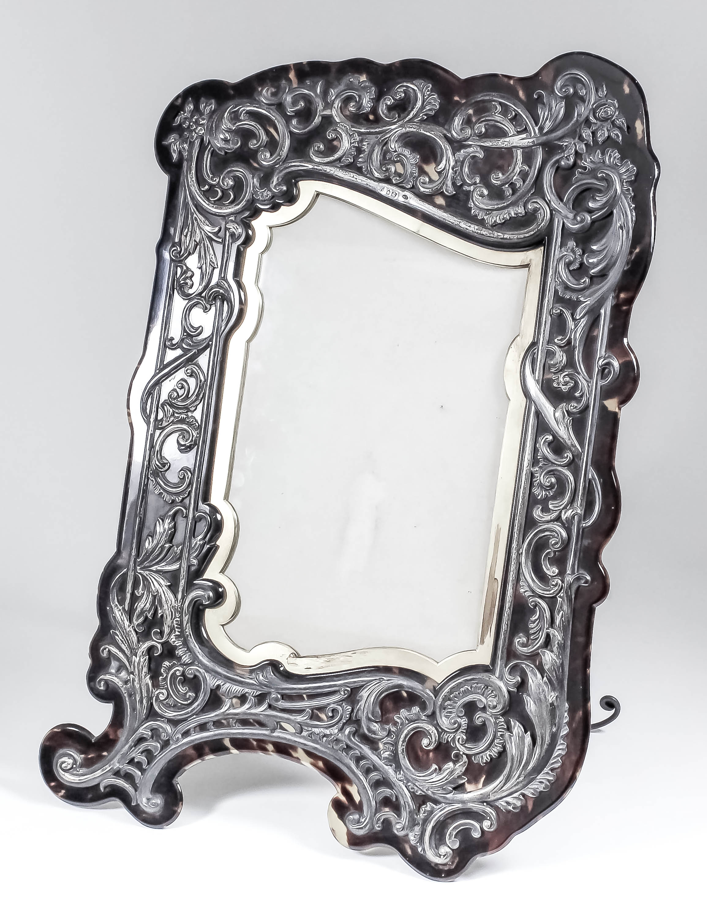 A late Victorian tortoiseshell and silver mounted rectangular photograph frame of shaped outline,