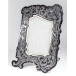 A late Victorian tortoiseshell and silver mounted rectangular photograph frame of shaped outline,