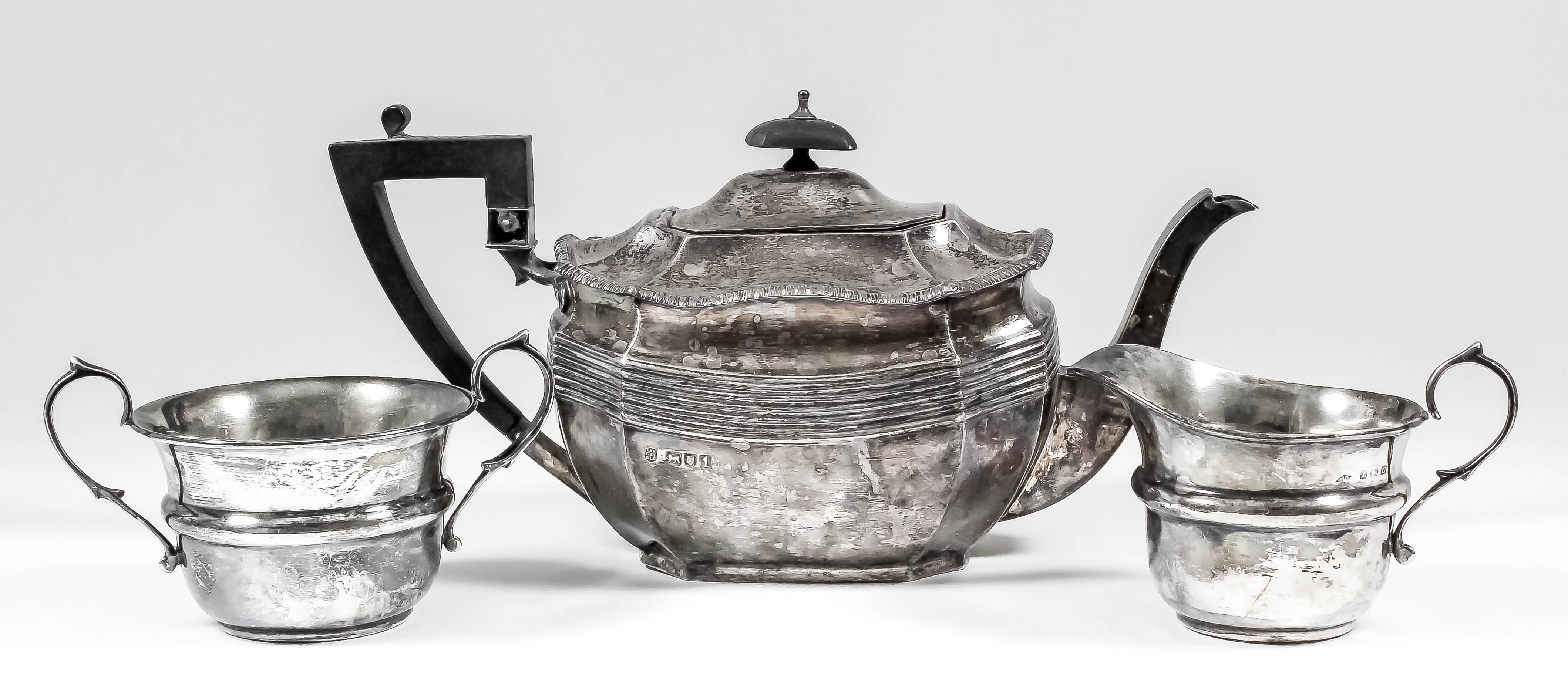 An Edward VII silver teapot of octagonal panelled form, with bead mounts, reeded band to body,