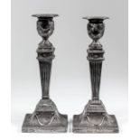 A pair of late Victorian silver pillar candlesticks of neoclassical design, with bead mounts to