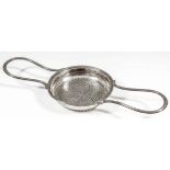 A George III silver circular two-handled lemon strainer with reeded loop handles, the circular