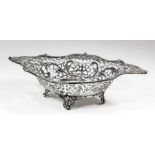 A late Victorian silver oval basket, the shaped rim with scroll and floral mounts, the sides pierced