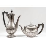 An Edward VII silver oval teapot with part fluted body, ebonised angular loop handle, 6ins high (